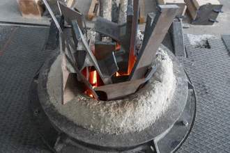 metal casting process with red high temperature fire in metal part factory