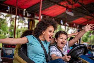 mother and son having fun on the carnival bumper cars
