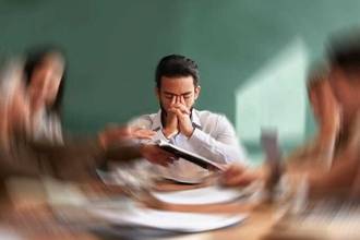 motion blur with a business man in a meeting feeling overwhelmed