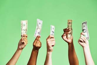 multiple hands holding up american cash