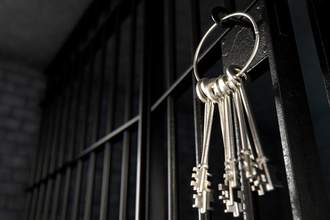 old jail cell with keys hanging on chain
