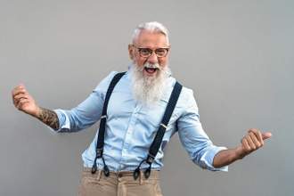 older gentleman with his hands outstretched looking happily at the camera