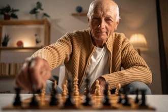 older man playing a game of chess
