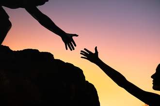 one person giving another a hand up