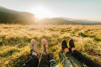 people enjoying the sunset in mountains