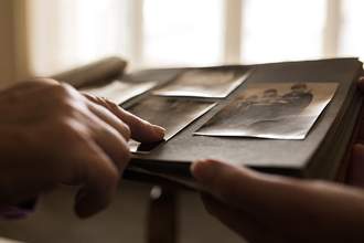 people looking at old photo album