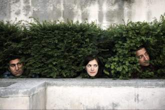 peoples heads peering out of bushes