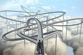 person standing at a crossroads with three different winding pathways