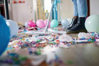 person sweeping floor after a party