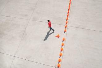 person walking through a row of cones to get to the other side