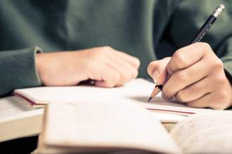 person writing in their notebook