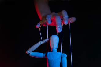 person-influences-puppet-strings
