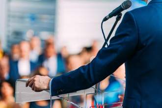 politician giving a speech in front of an audience