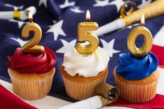 red white and blue cupcakes with the number candles 250