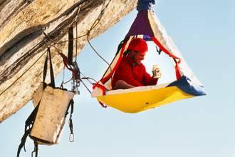 rock climber in hanging tent