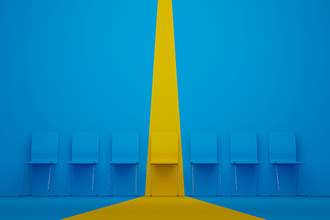 row of blue chairs with one painted yellow in a strip down the middle