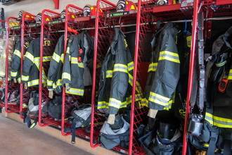 row of firefighter gear sitting in their lockers