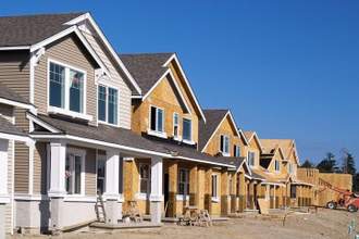 row of houses under construction at different phases