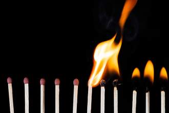 row of matches lighting on fire