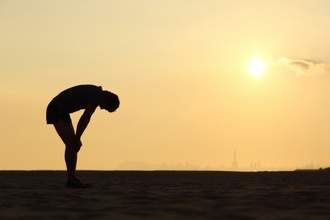 runner bent over to catch breath