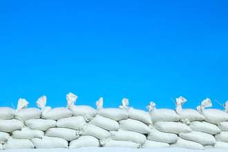 sandbags being piled up in front of a blue background