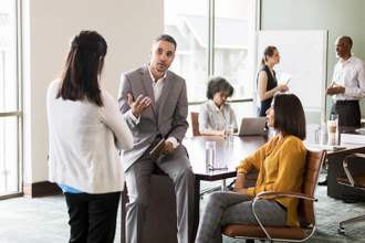 serious businessman talking with associates