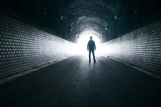 silhouette-of-man-in-dark-tunnel