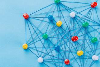 small network of strings connecting thumb tacks