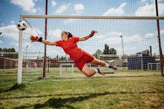 soccer goalie diving for the ball