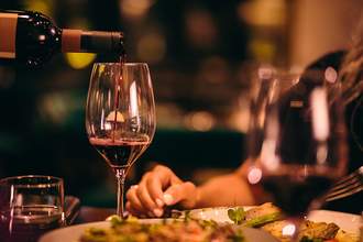 sommelier pouring wine