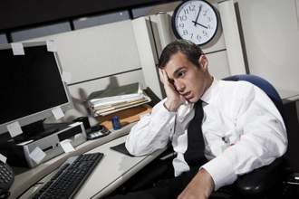 stressed businessman in office cubicle
