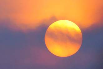 sun through haze at sunrise