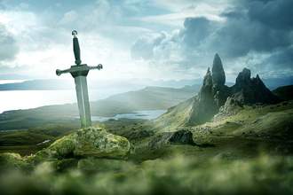 sword in stone with hills behind it