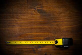 tape measure on wooden background