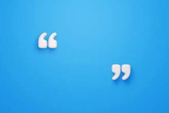 three dimensional quotation marks sitting against a blue background