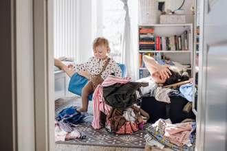 toddler creating a chaotic mess while their mom looks distraught