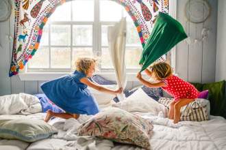 two children having a pillow fight