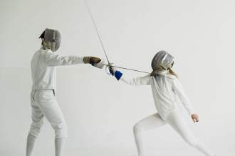 two fencers training attack exercises