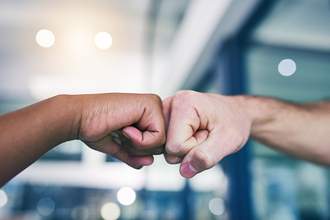 two hands fist bumping