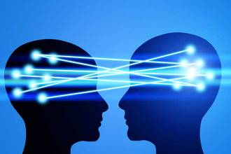 two heads facing each other with glowing lines connecting one to the other