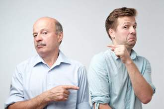 two men side eyeing each other and pointing as if its the other persons fault