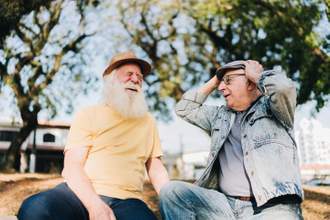 two older men men talking in the park