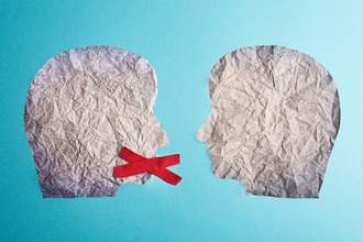 two paper faces in which one has a red x over the mouth