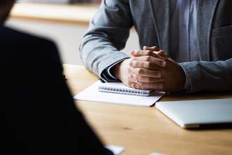 two people sitting across table