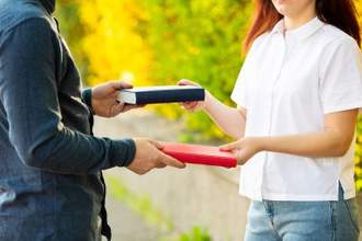 two people trading books