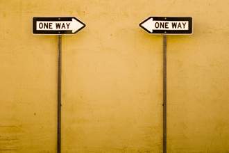 two-one-way-signs-facing-each-other