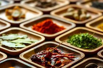 variety of colorful organic dried vibrant food spices in wooden trays