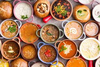 variety of soups in colorful bowls