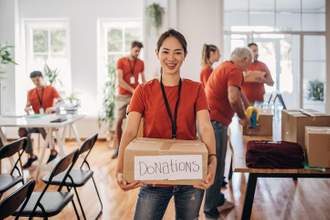 volunteer holding donation box