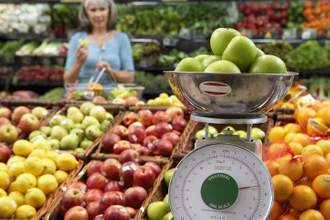 weighing a bundle of apples on an in store weighing scale